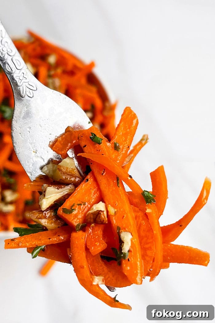 Fork Full of Carrot Coleslaw on White Background- Closeup Shot