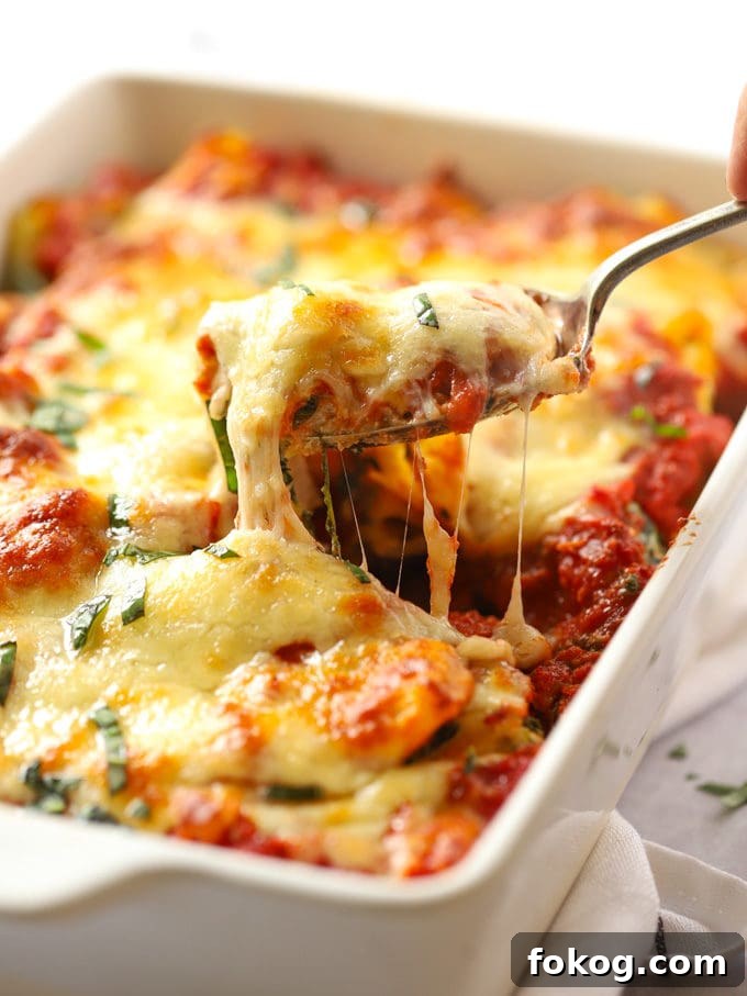 Cheese pulling from a Spinach and Ricotta Pasta Bake recipe.