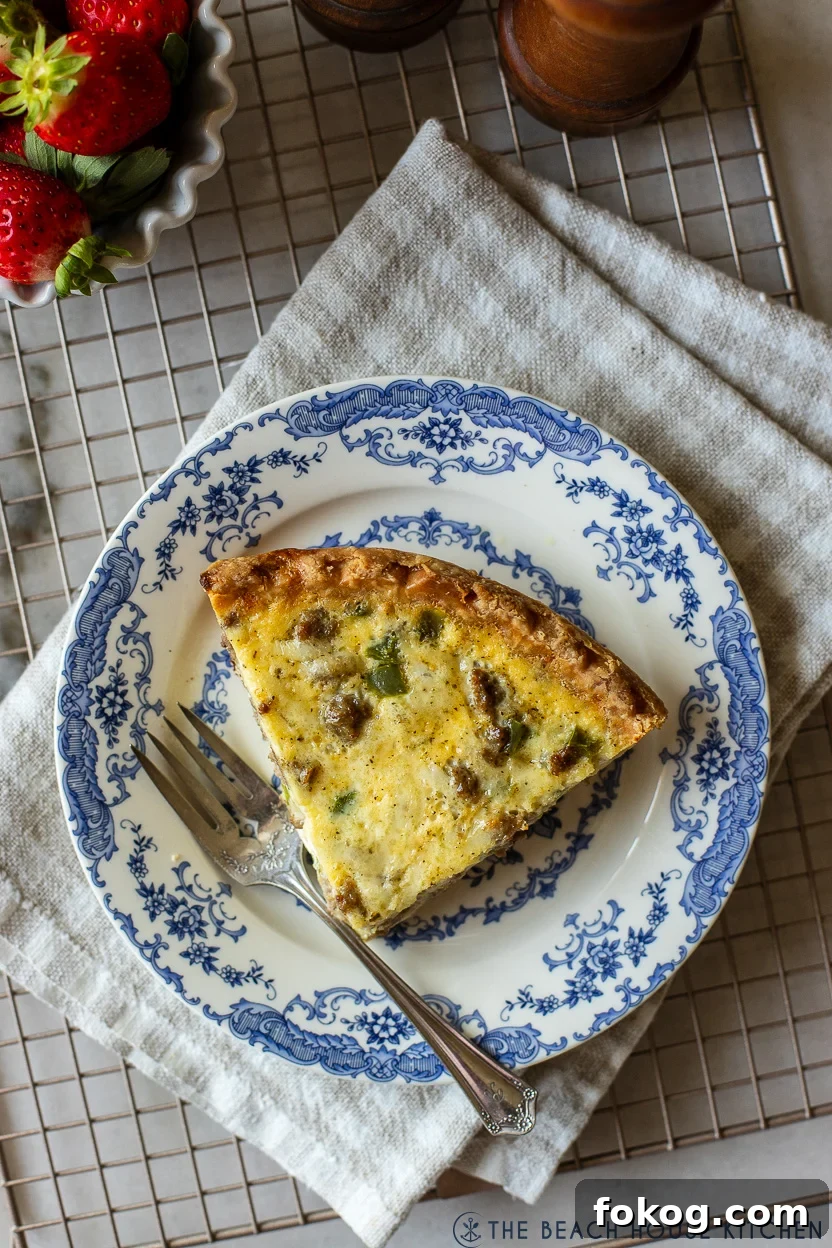 Up close overhead photo of a slice of quiche on a blue and white plate