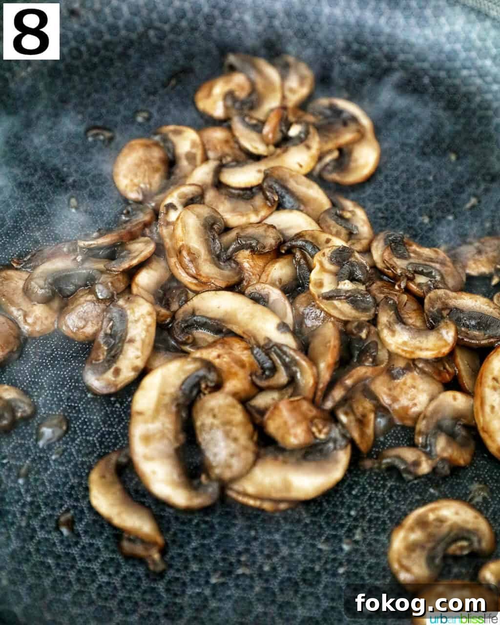cooking sliced mushrooms in a cast iron skillet.