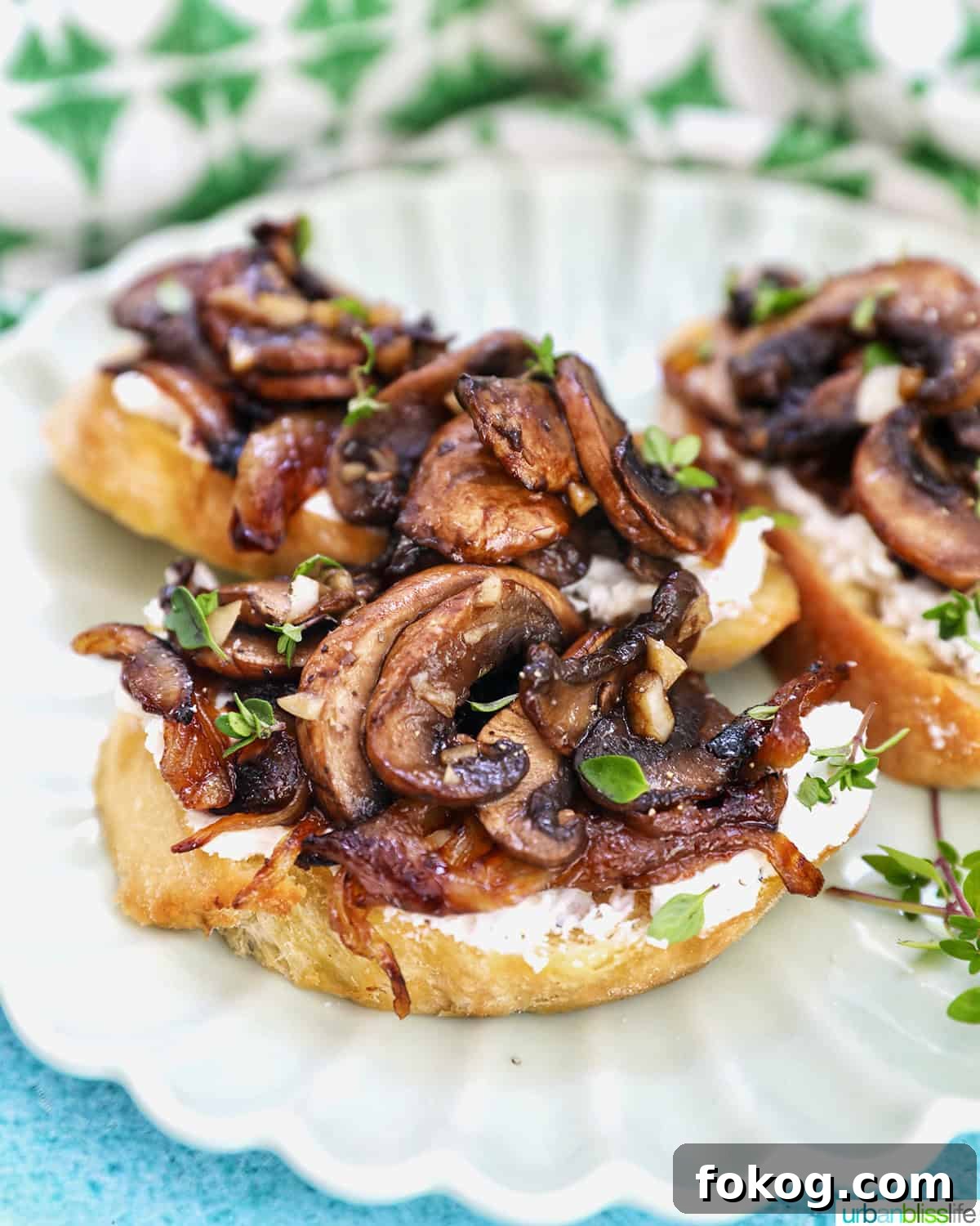 three mushroom crostini on a plate.