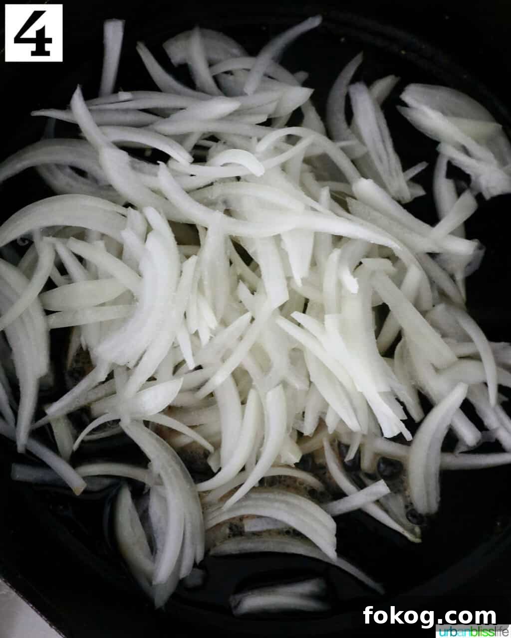 sliced onions in a cast iron skillet.