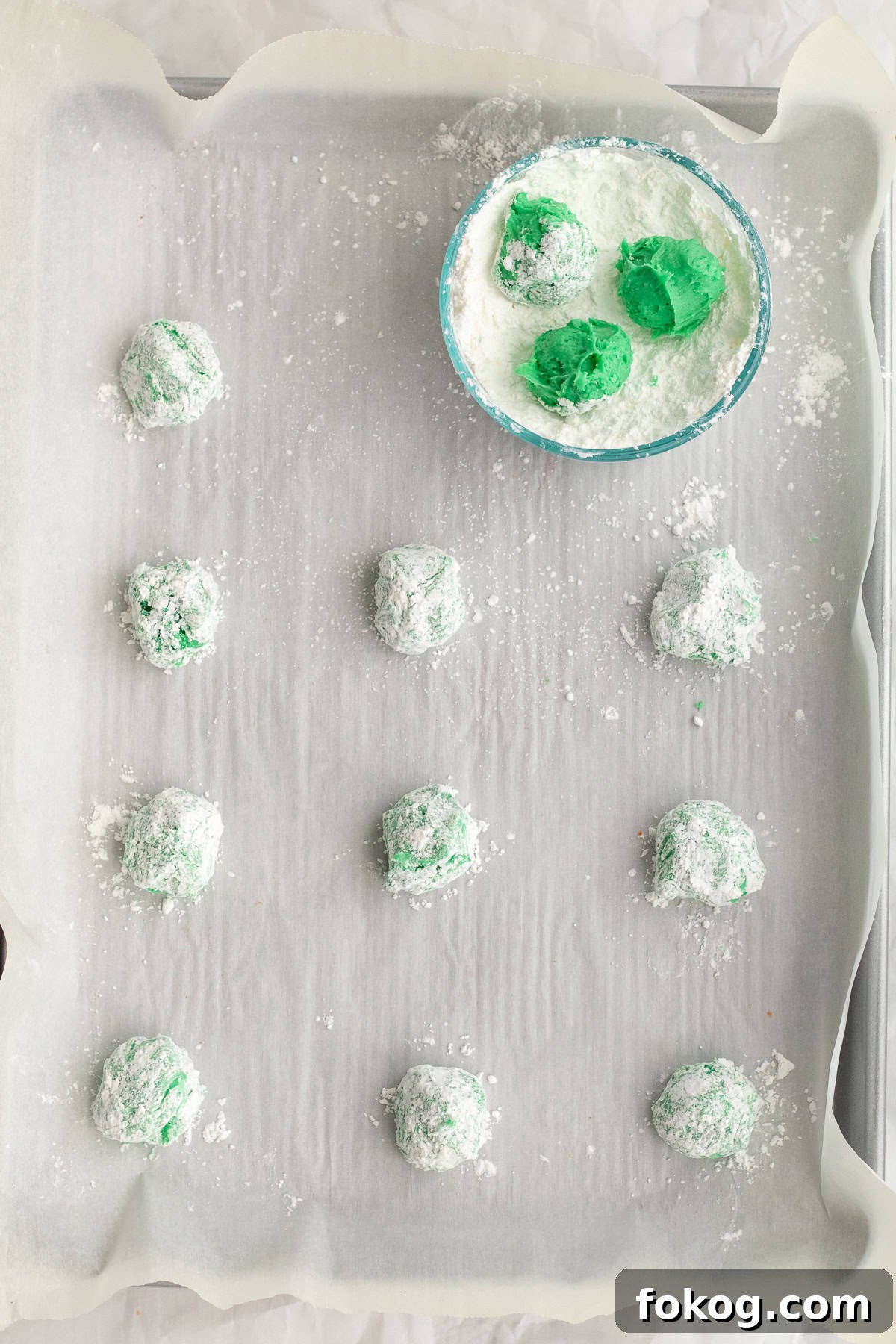 green cookie dough rolled in powdered sugar