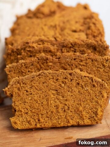 Sliced pumpkin bread on a wooden serving board