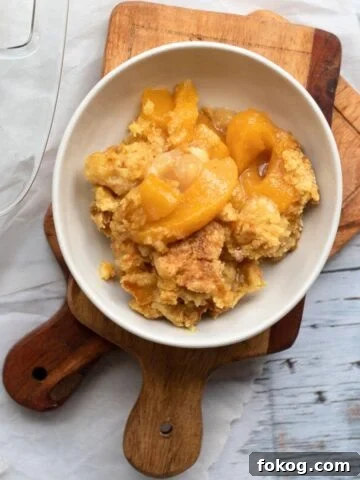peach cobbler in a white bowl