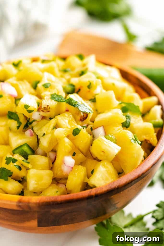 Spicy Jalapeño Pineapple Salsa Recipe for Grilling and Tacos 2 Wooden bowl filled with pineapple jalapeno salsa.