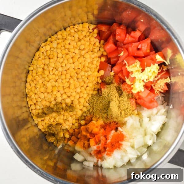 Restaurant-Style Dal Tadka Recipe Ready in 25 Minutes 4 Split pigeon peas, chopped tomatoes and onions, grated ginger and spices in a pot