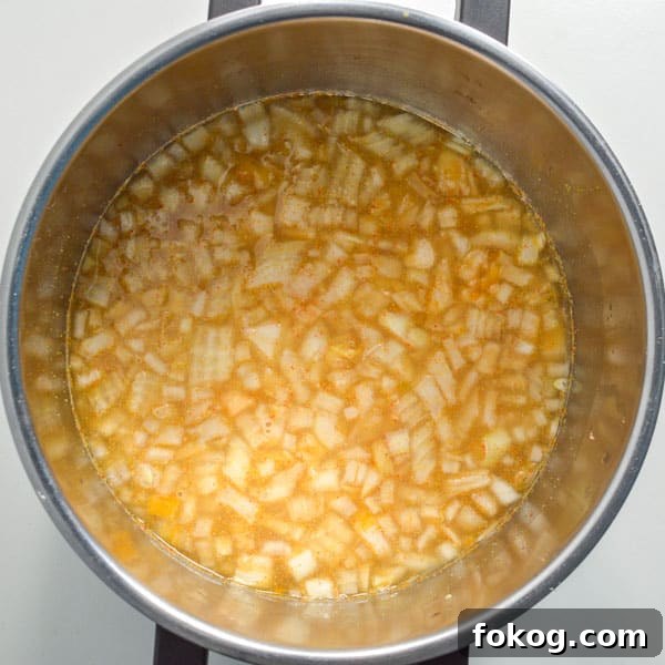 Restaurant-Style Dal Tadka Recipe Ready in 25 Minutes 5 Yellow water with chopped onions and lentils in a pot