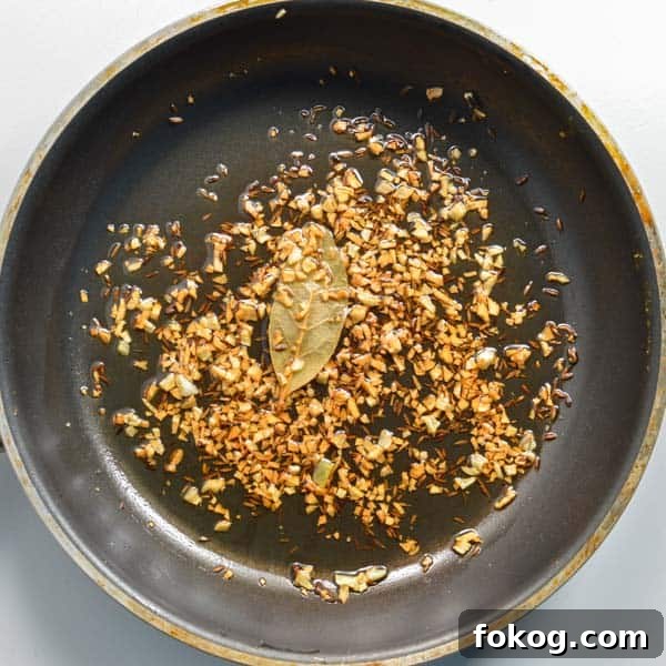 Restaurant-Style Dal Tadka Recipe Ready in 25 Minutes 8 Browned garlic, cumin and a bay leave in a pan
