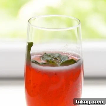 Prosecco and strawberry cocktail in a champagne glass.