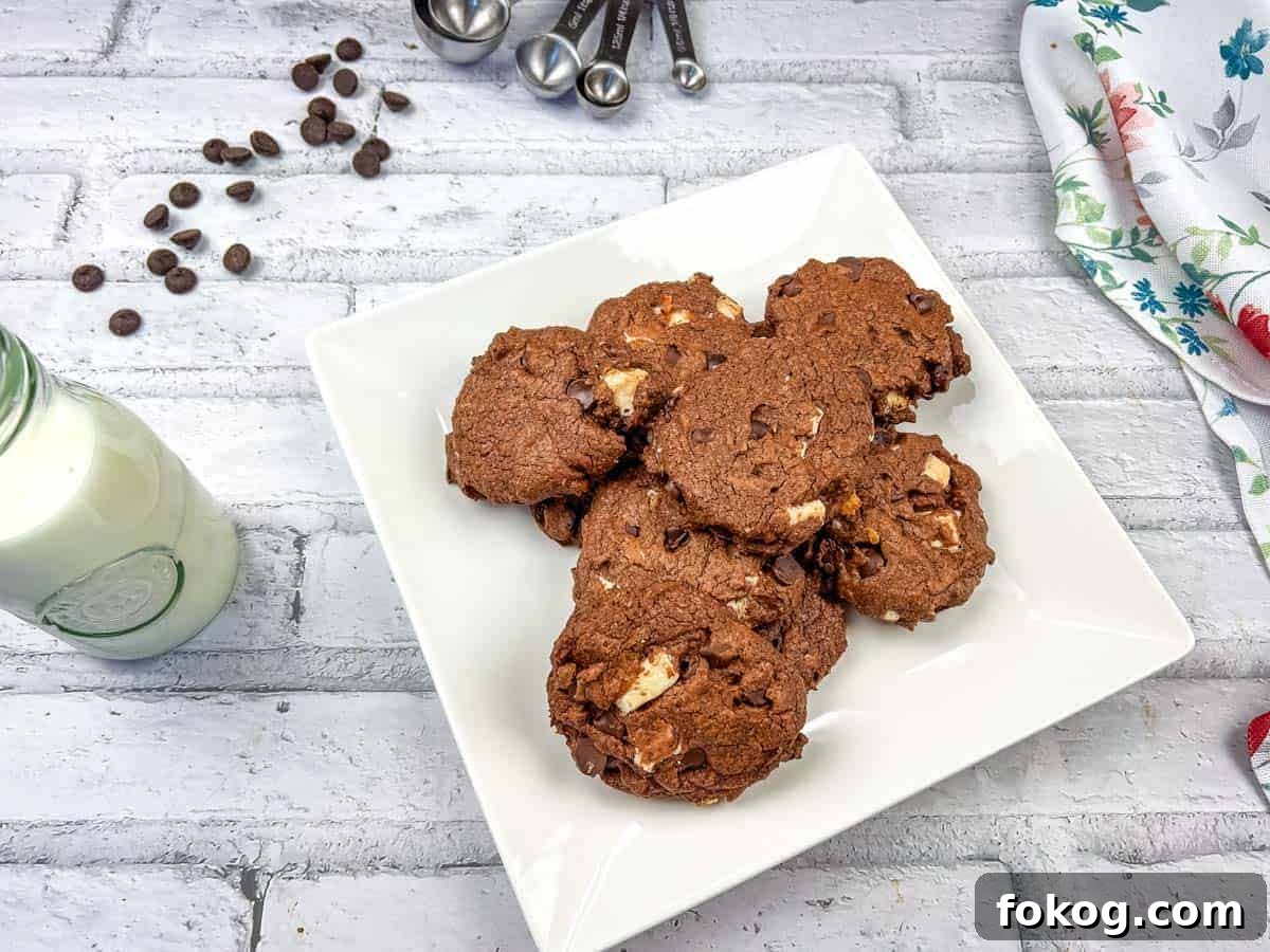Chocolate overload cookies on a white plate.