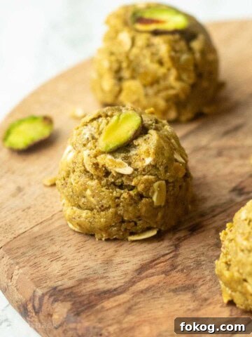 Pistachio protein ball on wooden board.