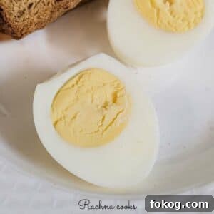 Boiled egg cut in half on a white background