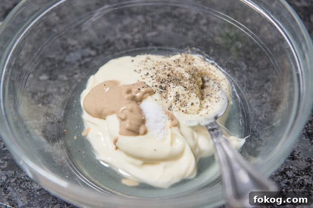 Chicken Salad Dressing in Bowl with Mayonnaise, Mustard, Salt, Black Pepper, Lemon Juice