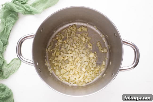 Onion and garlic sauteing in a large pot.