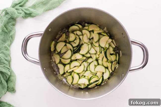 Raw zucchini slices in a large pot.