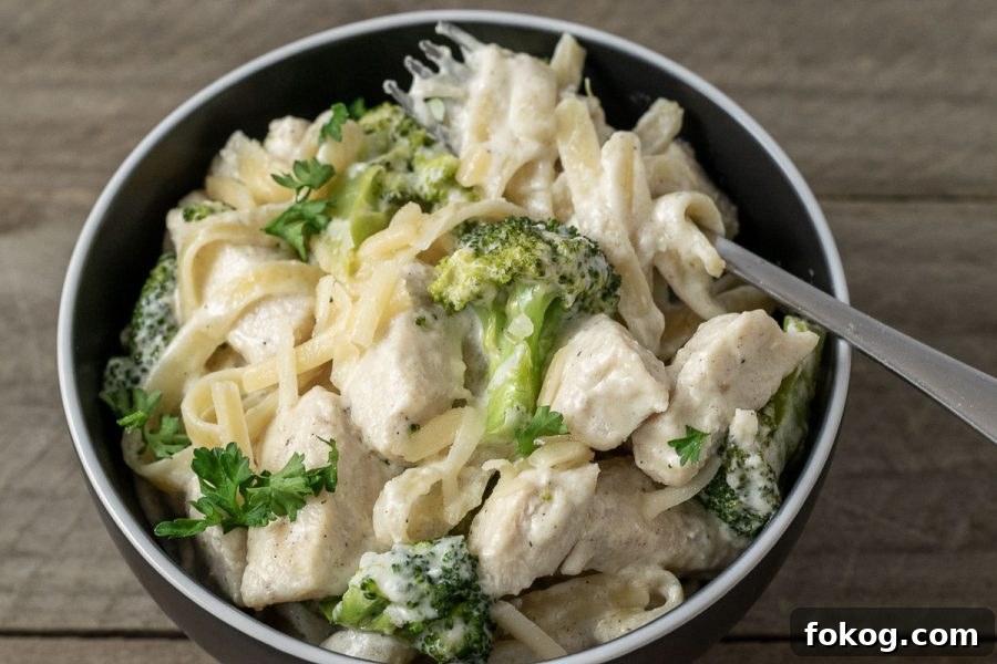 Creamy Chicken Fettuccine Alfredo Recipe for Weeknight Dinner 9 a bowl filled with Chicken Fettuccine Alfredo with Broccoli.