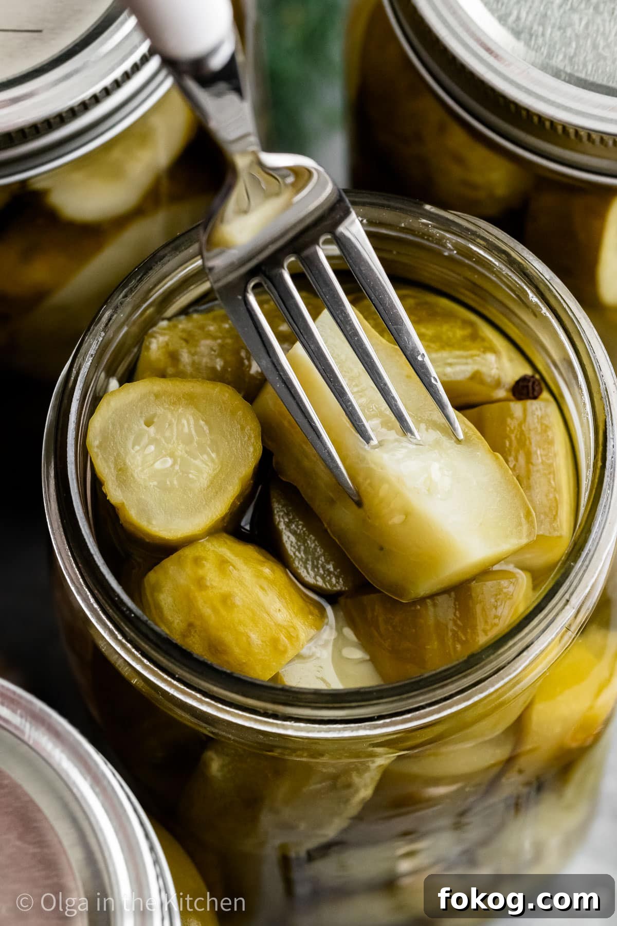 These easy homemade dill pickles are perfectly crisp, tangy and refreshing. They are seasoned with just the right amount of dill and garlic. Whether you’ll serve them with hot dogs, hamburgers or simply enjoy as a snack, they will be good for up to a year in your pantry. Opened jar of homemade dill pickles.