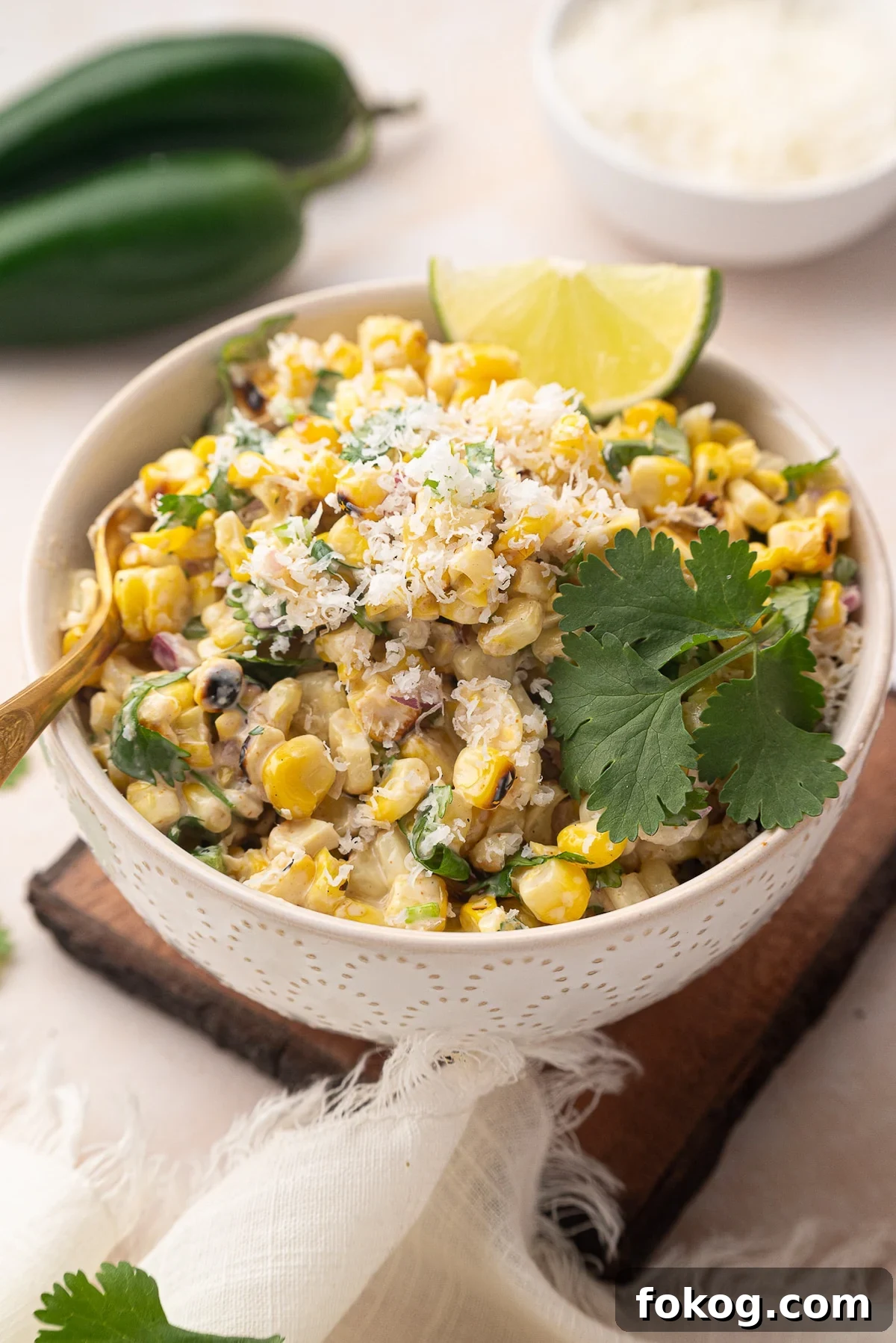 Mexican Street Corn Salad (Grilled Elote-Style) 2 white bowl filled with Mexican corn salad garnished with lime and cilantro