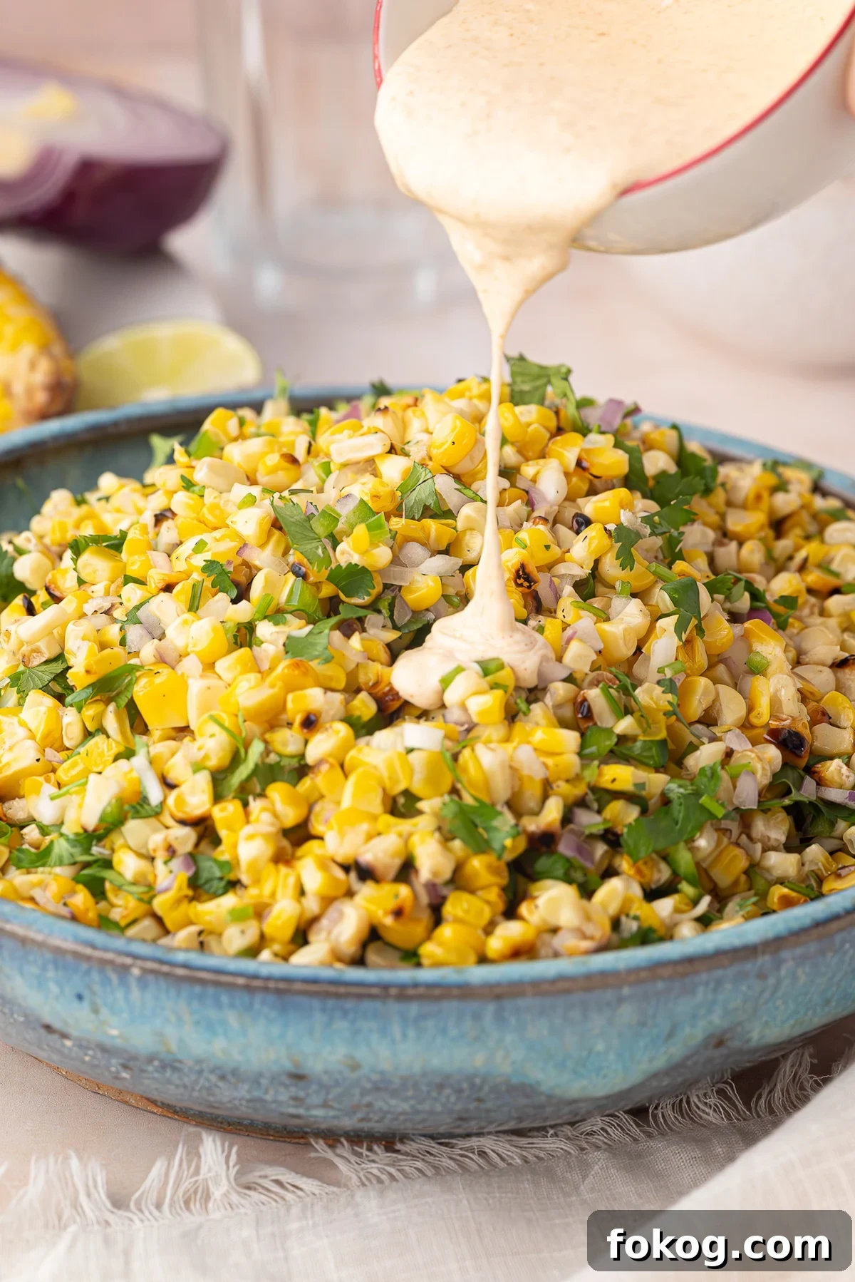 Mexican Street Corn Salad (Grilled Elote-Style) 4 pouring dressing on street corn salad