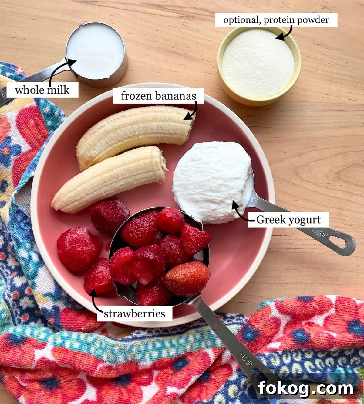 Strawberry Banana Yogurt Smoothie Recipe — Creamy & Refreshing 4 The ingredients needed to make a strawberry banana smoothie with yogurt - bananas, strawberries, milk, Greek yogurt, and protein powder.