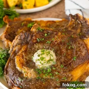 Air Fryer steak with garlic butter and herbs on top.