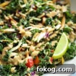 Kale salad topped with peanut dressing.