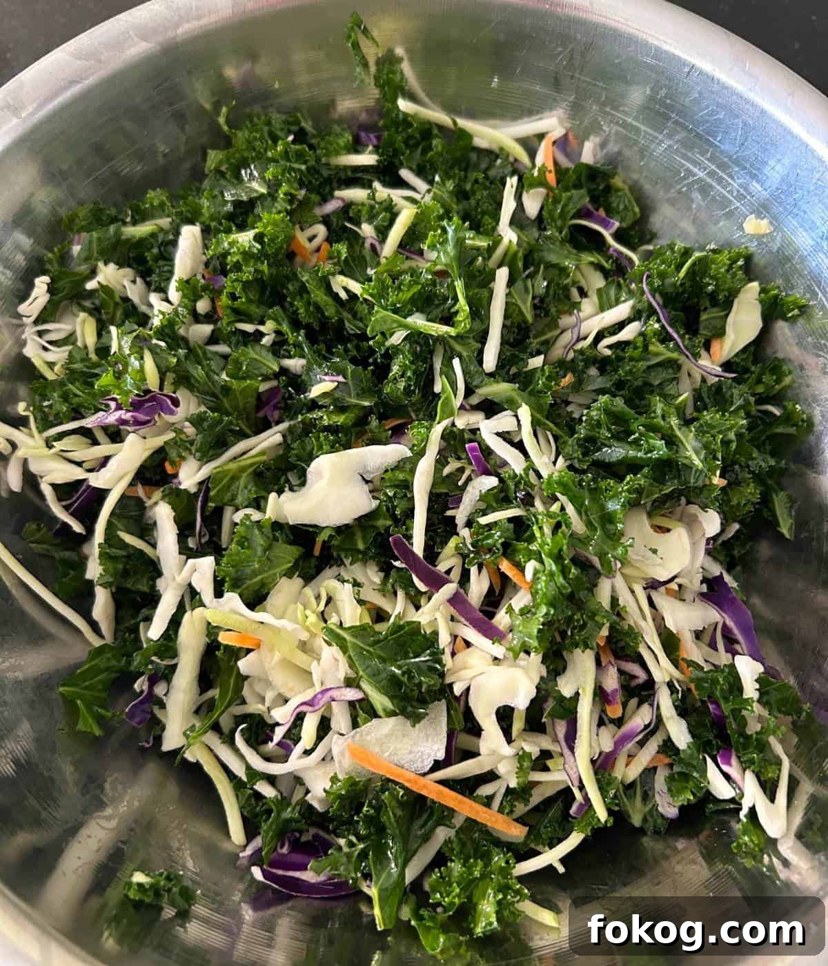 Kale and coleslaw mix in bowl.