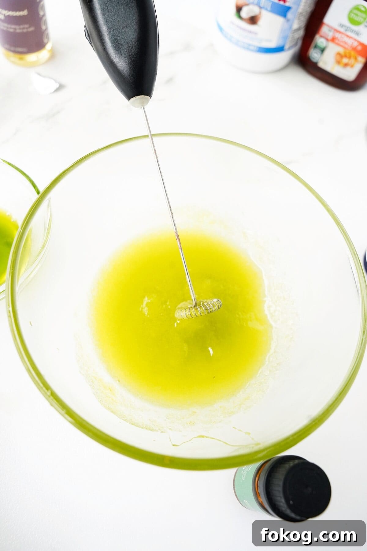 glass bowl whipping avocado and essential oil together into a thick consistency for hand cream