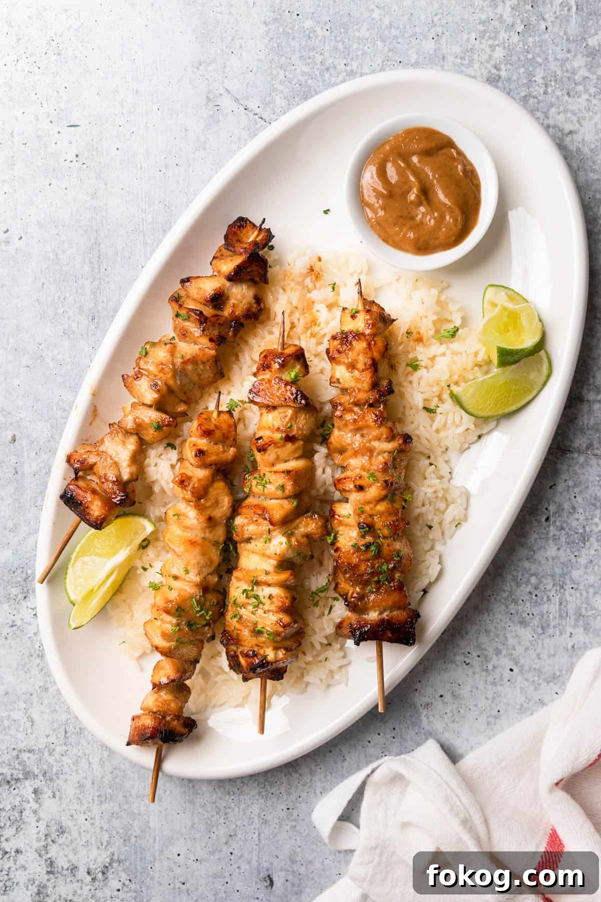 Air Fryer Chinese Chicken Skewers Recipe with Sticky Glaze 2 Four Chinese chicken on a stick over a bed of rice.