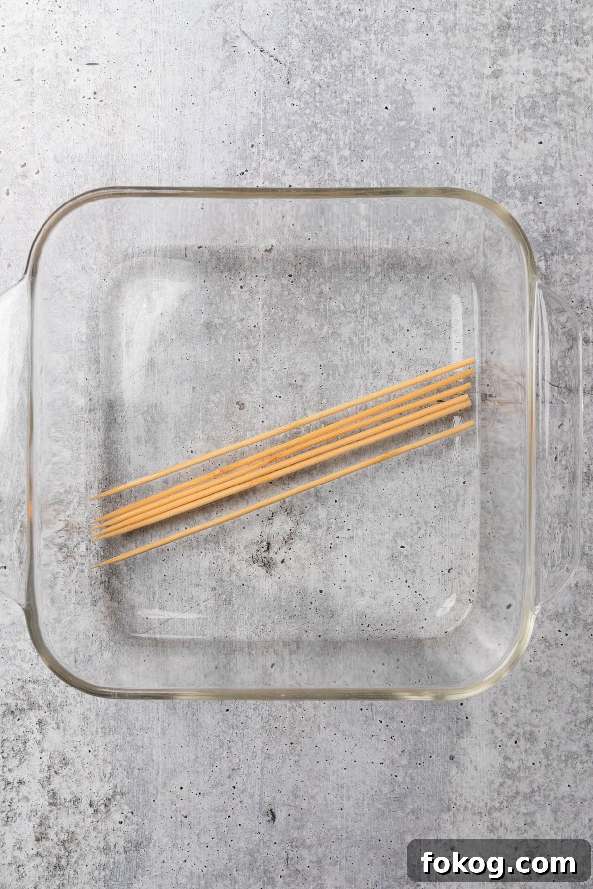Air Fryer Chinese Chicken Skewers Recipe with Sticky Glaze 4 Soaking wooden skewers in water.