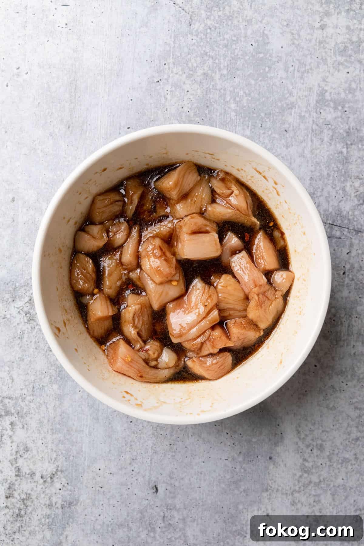 Air Fryer Chinese Chicken Skewers Recipe with Sticky Glaze 5 Marinating cut up pieces of chicken.