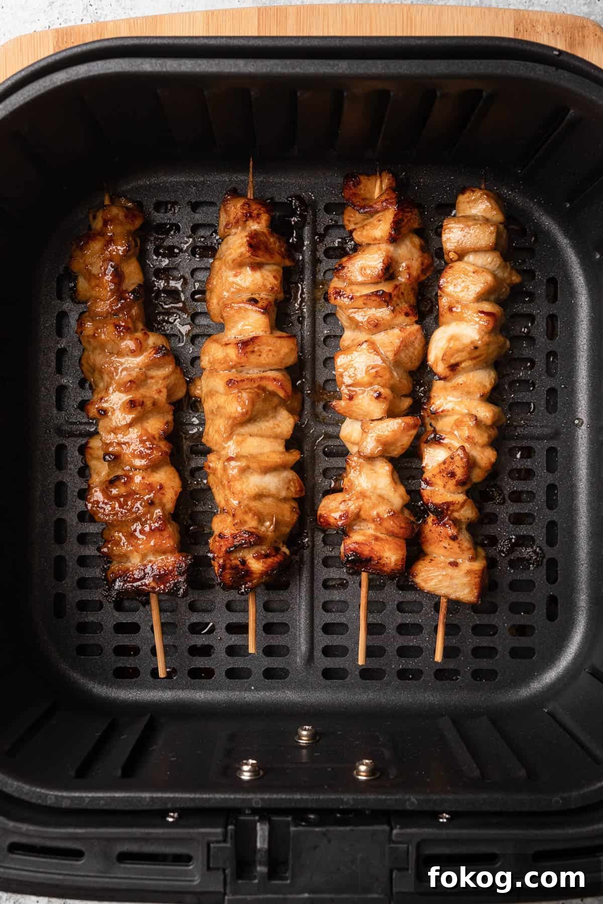 Air Fryer Chinese Chicken Skewers Recipe with Sticky Glaze 7 Skewered chicken in air fryer basket after cooked.