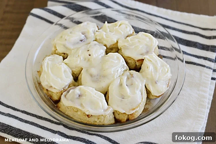 cinnamon rolls made from 2 ingredient dough with cream cheese frosting in a pie pan