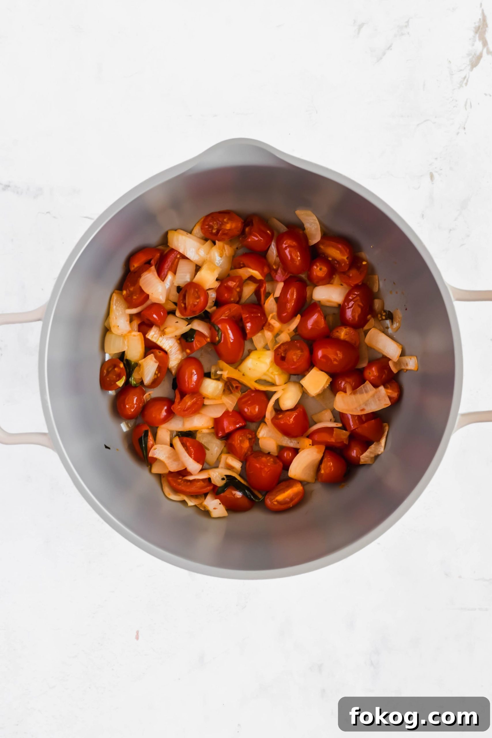 Cooked vegetables for Cauliflower Gnocchi Soup with sausage in a stock pot.