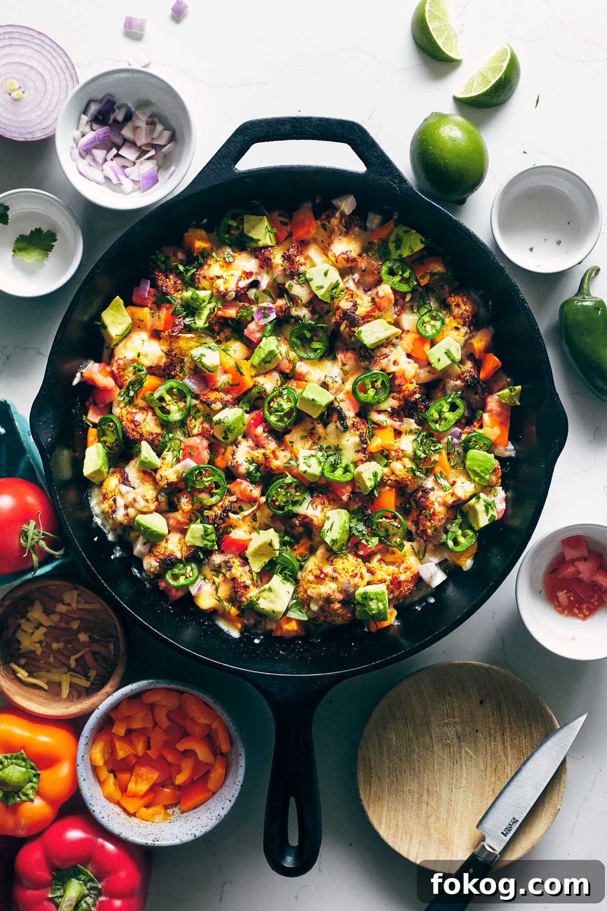 Spicy Cauliflower Nachos with Melted Cheese & Jalapeños 2 Spicy cauliflower nachos after being baked in a cast iron pan