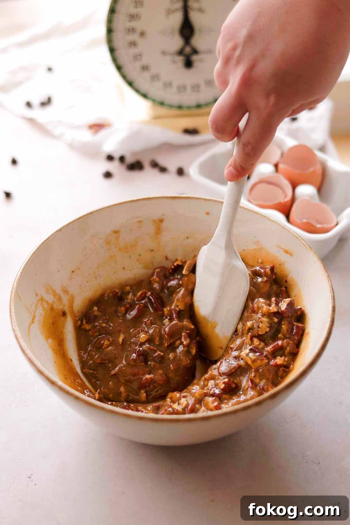 Decadent Pecan Pie Brownies Recipe — Gooey Pecan Swirl Dessert 14 mixing pecans into pecan pie butter