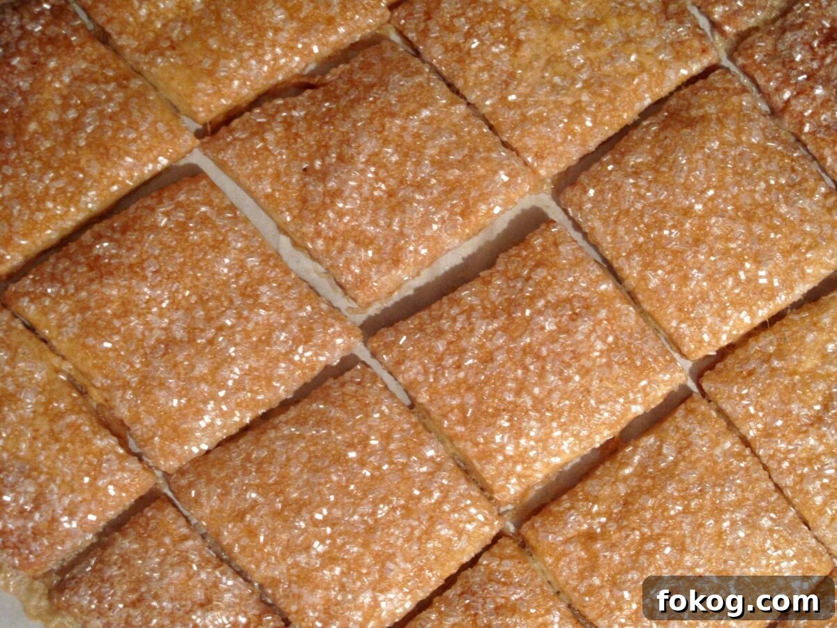 Maple Crisp Cookies with a Shimmering Sugar Glaze 3 Rows of square cookies coated in white decorating sugar.