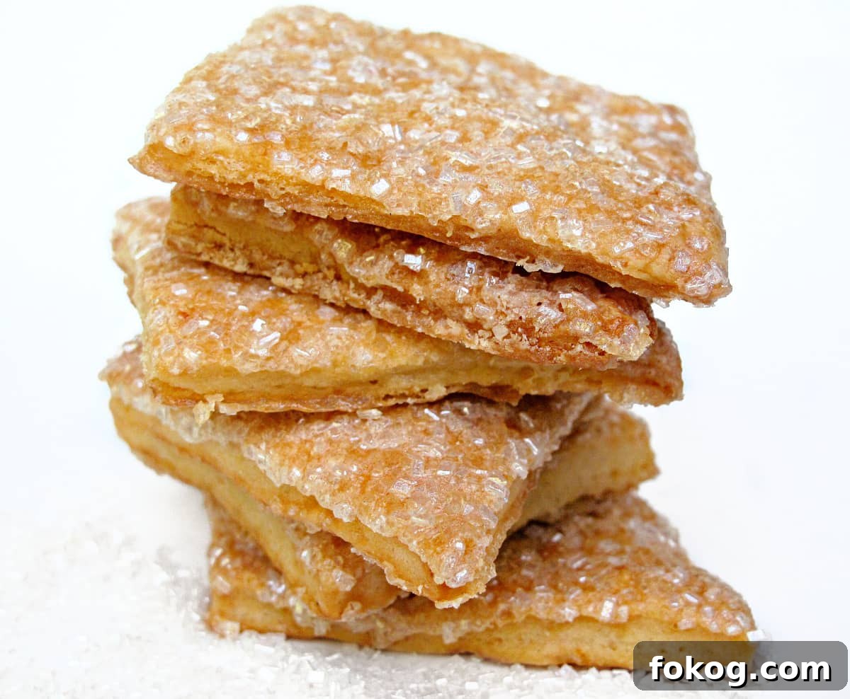 Maple Crisp Cookies with a Shimmering Sugar Glaze 5 Stack of sugar coated square cookies with thin edges.