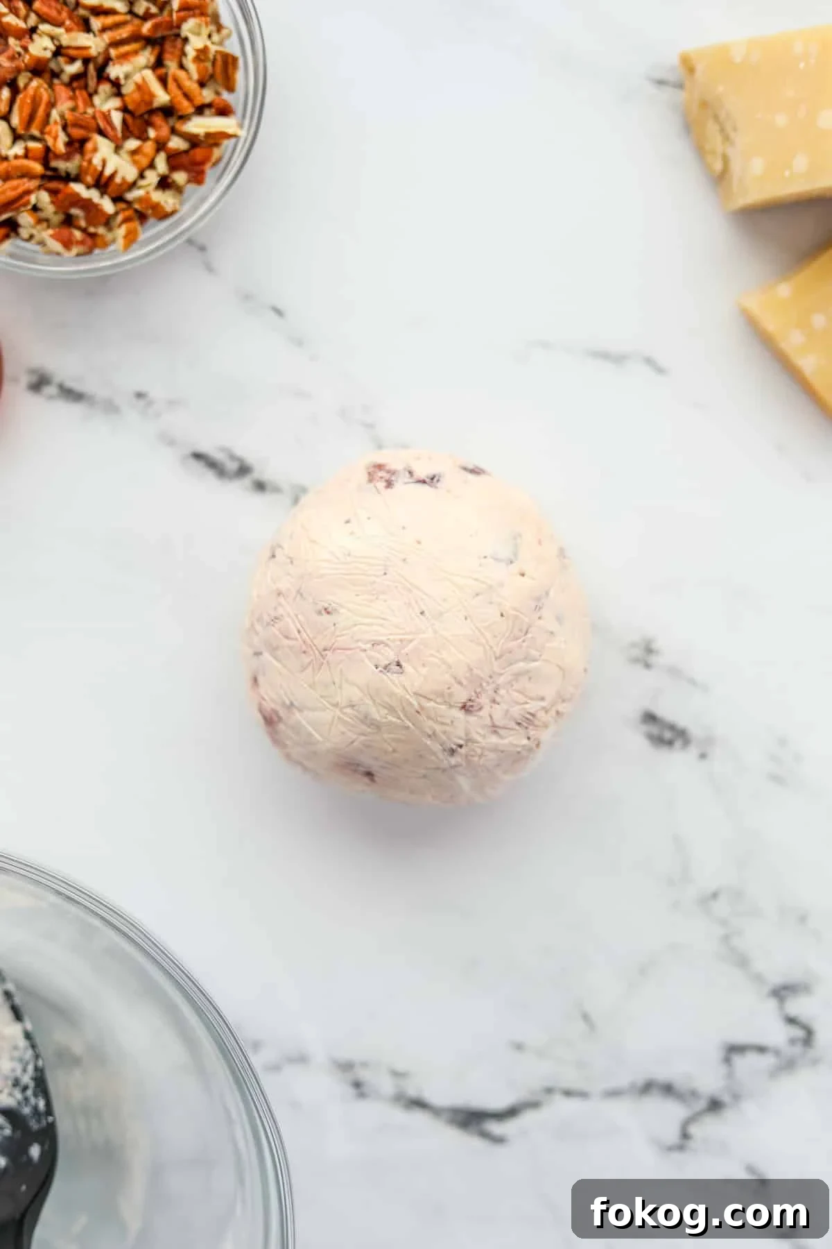 Creamy Boursin Cheese Ball Recipe for Parties and Holidays 5 A tightly wrapped ball of softened Gournay cheese.