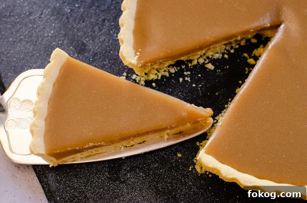 slice of butterscotch tart being lifted up to serve