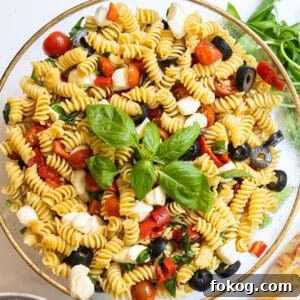 Classic Italian Pasta Salad Recipe with Tangy Vinaigrette and Veggies 10 Italian pasta salad in large bowl garnished with basil.