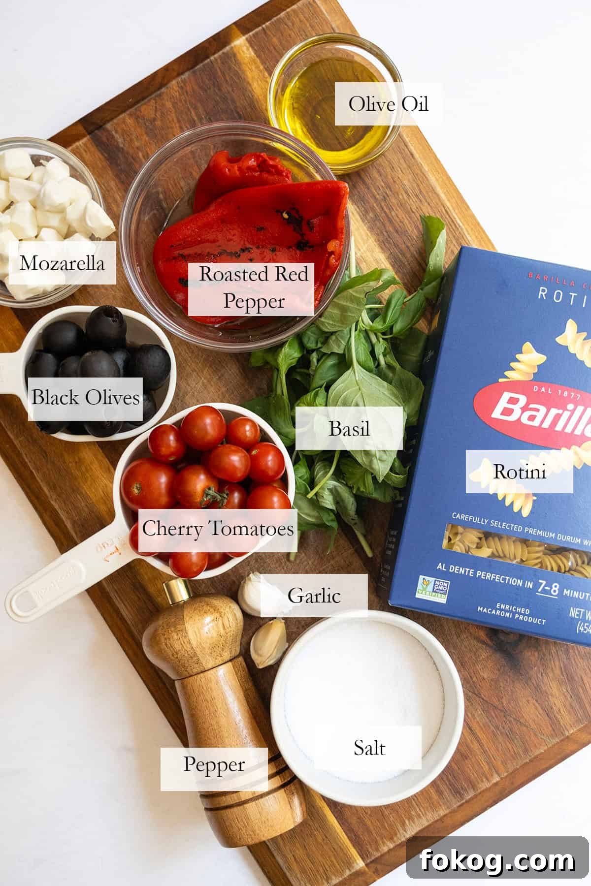 Classic Italian Pasta Salad Recipe with Tangy Vinaigrette and Veggies 3 ingredients for the pasta salad on a cutting board.