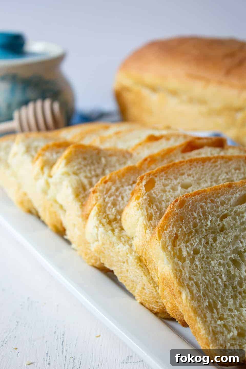 Slices of white bread arrange in a row overlapping each other.