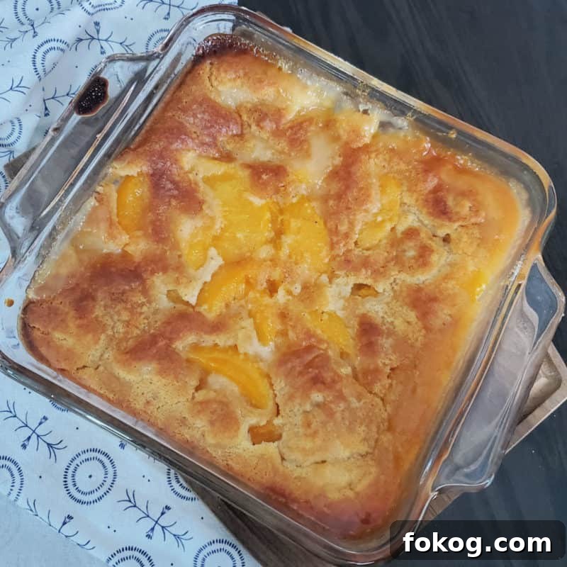 Simple Bisquick Recipes for Delicious Breakfasts and Snacks 4 Bisquick peach cobbler in a glass baking dish by a cloth napkin