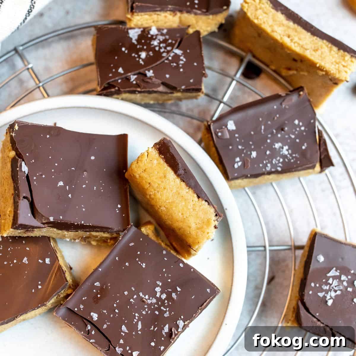 Buckeye Bars Recipe: Classic Peanut Butter Chocolate Treats 6 Bars on a white plate with a sprinkle of salt.