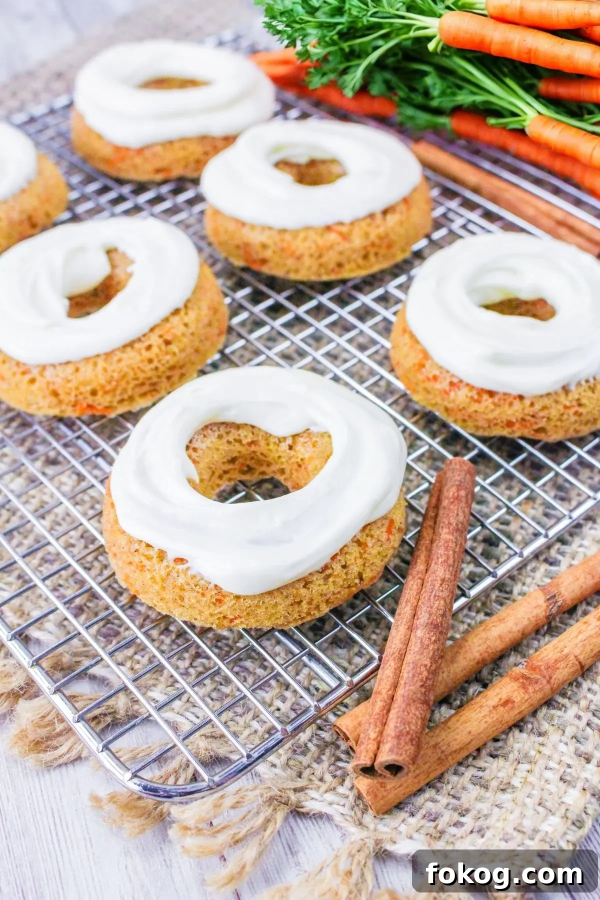 A wire rack with a few gluten free carrot cake donuts.
