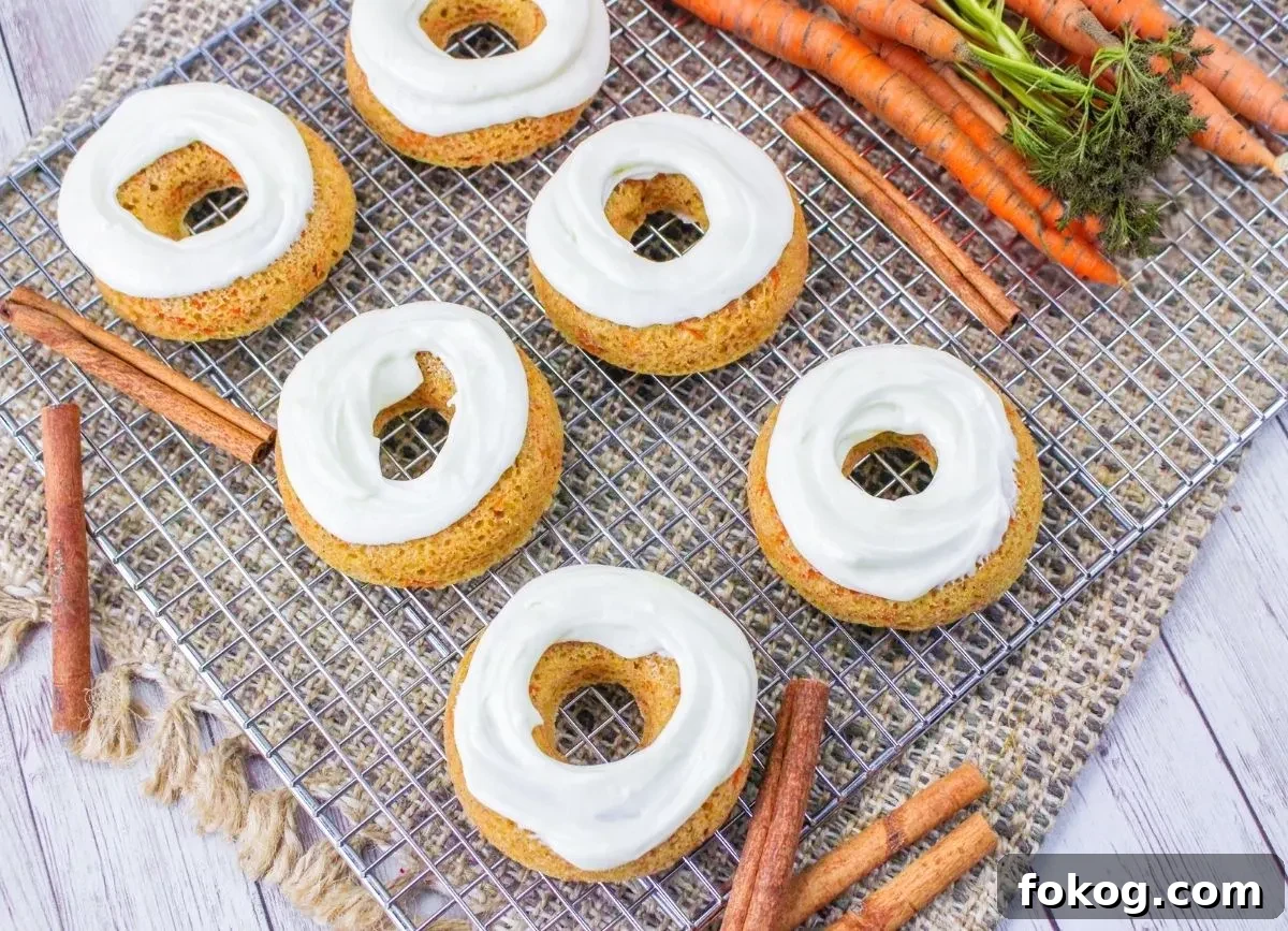 Quite a few baked carrot cake donuts.