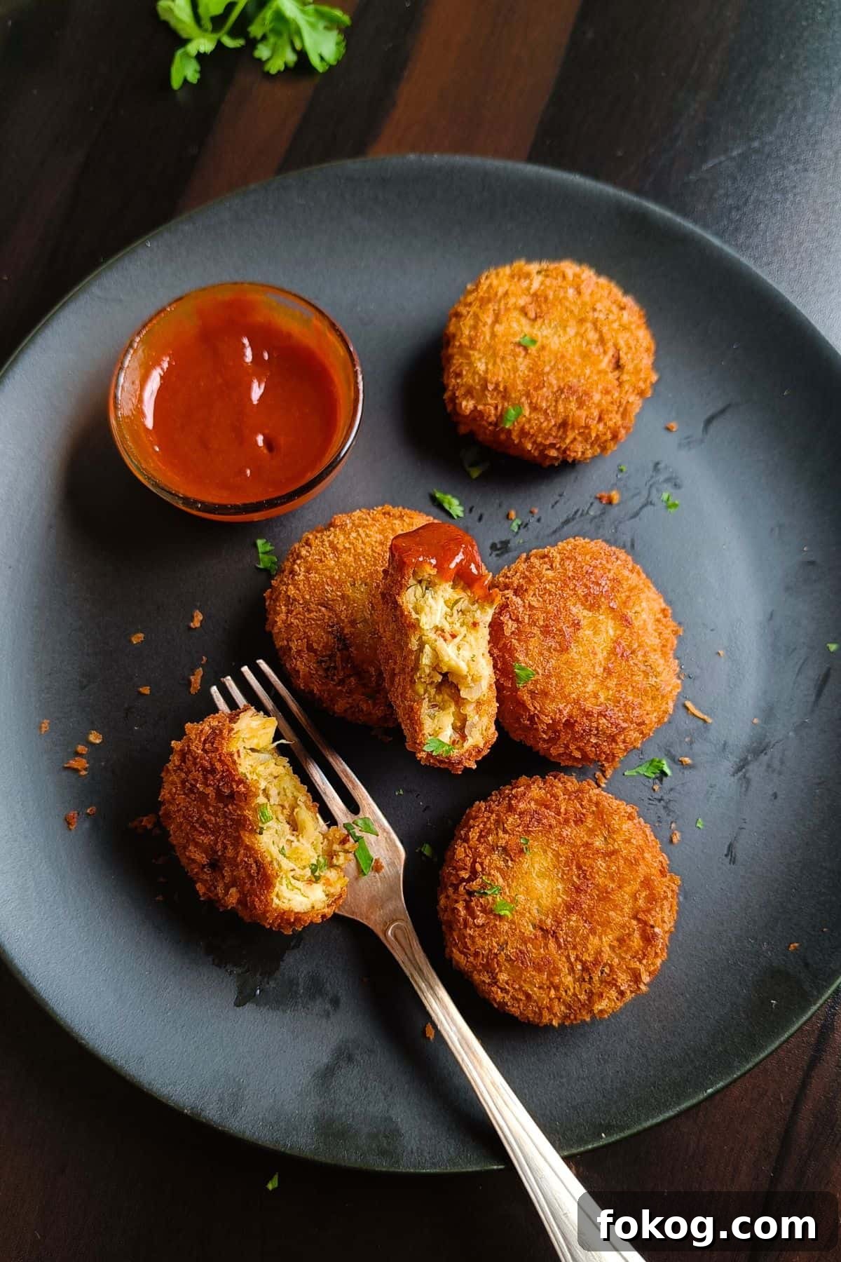Image showing chicken cutlets served on a black platter.