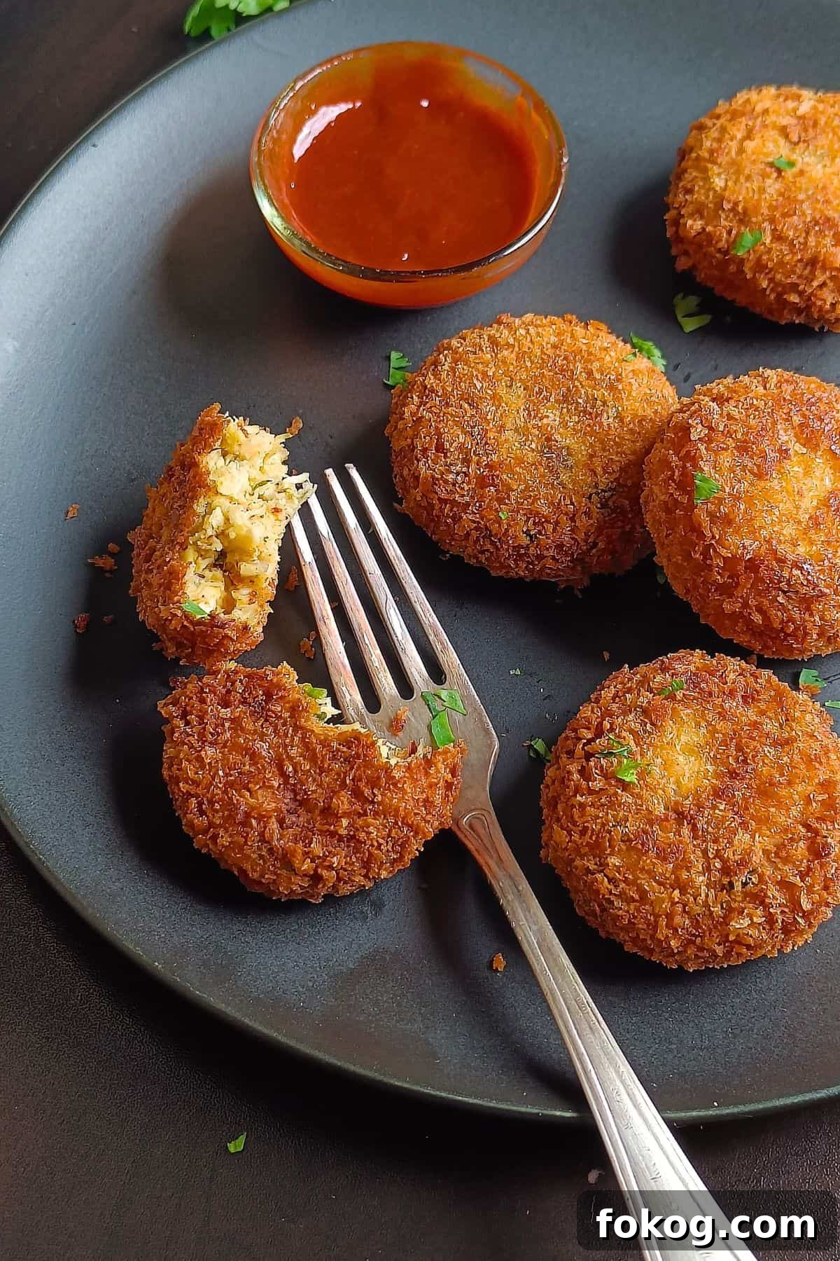 Image showing chicken potato cutlets served on a black platter.